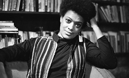 Toni Cade Bambara surrounded by books